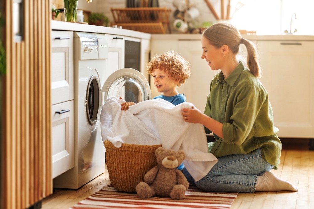 Mother and son doing laundry together with a safe and natural detergent