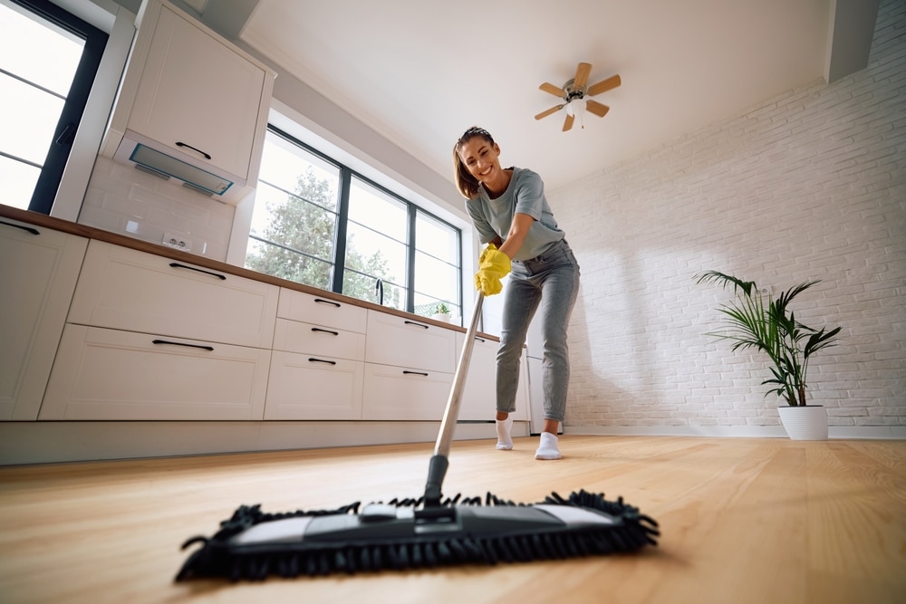 Woman mopping her floor with Clean Habits floor cleaner using Synbio technology